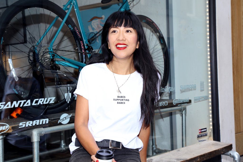 Female entrepreneur Celeste Wong is photographed smiling in Vancouver while wearing a Brunette the Label shirt.