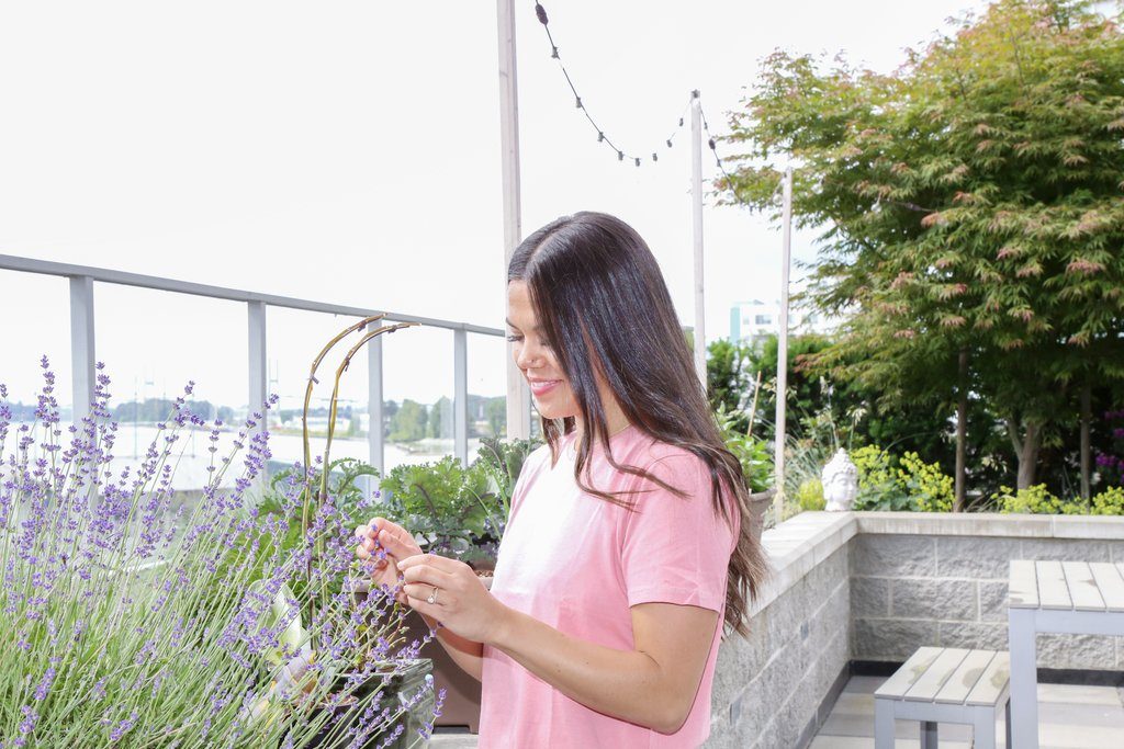 Vancouver registered dietitian Lindsay Pleskot admires her garden on her patio in New Westminster, BC.