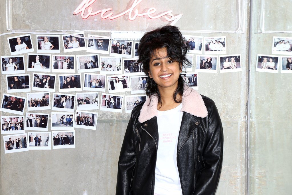 Michelle Gill is photographed standing in front of the Babes Supporting Babes feature wall at the Brunette Flagship Store in Vancouver.