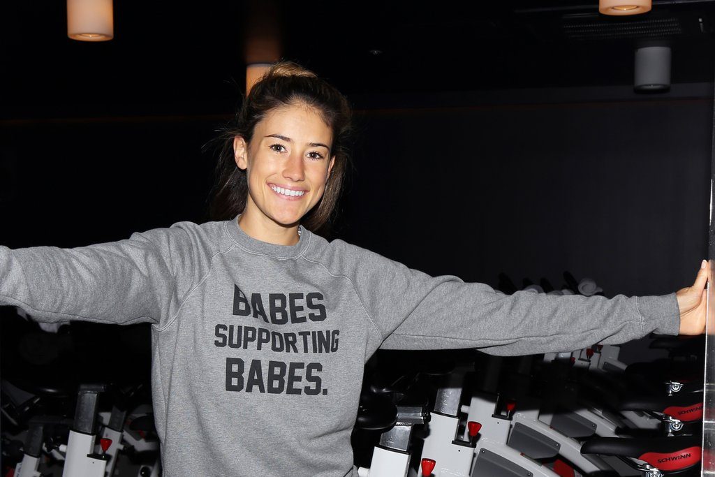 Female entrepreneur and communications-specialist Naomi White of Naomi White Communications is photographed wearing the Babes Supporting Babes Crew Neck Sweatshirt by Brunette the Label.