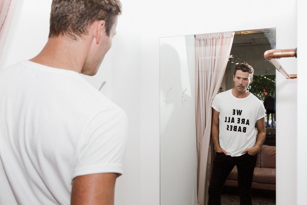 Ryan Pugsley is photographed wearing the We Are All Babes Crew Neck Tee from Brunette the Label.