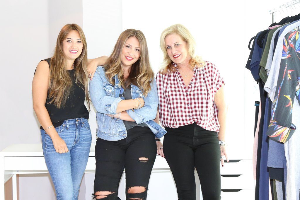 The team of female entrepreneurs behind the romper and loungewear company Smash + Tess are photographed standing and smiling.