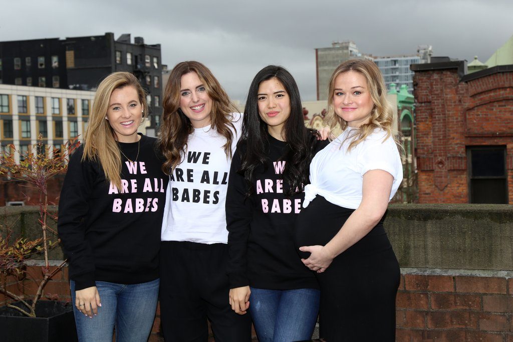 The team from Saje Natural Wellness is photographed standing and smiling in Brunette the Label clothing.