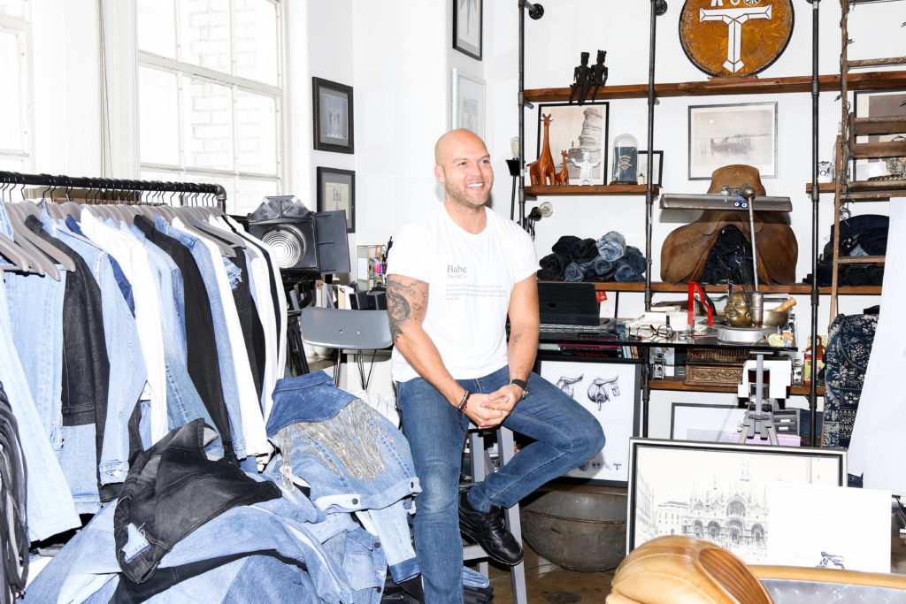 Adam Taubenfligel of Triarchy Denim is photographed sitting inside of his office and loft in Los Angeles.