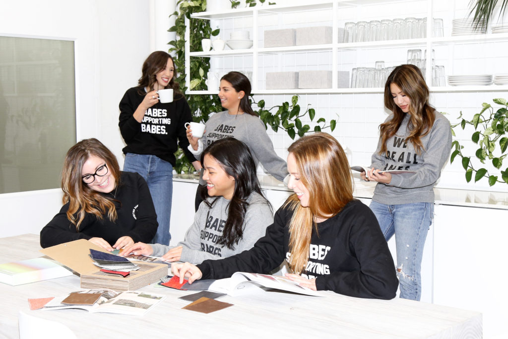 The Vancouver-based Article furniture trade team is photographed wearing the "Babes Supporting Babes" Crew Neck Sweatshirt by Brunette the Label.
