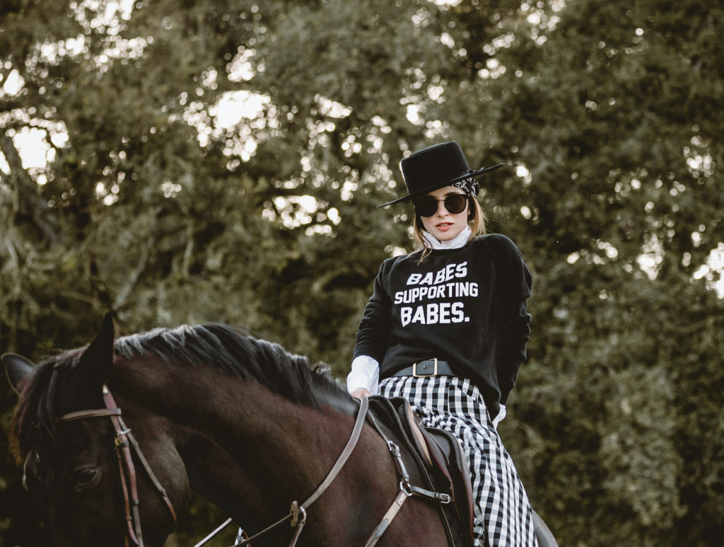 Female entrepreneur Alli Addison is photographed riding a horse.