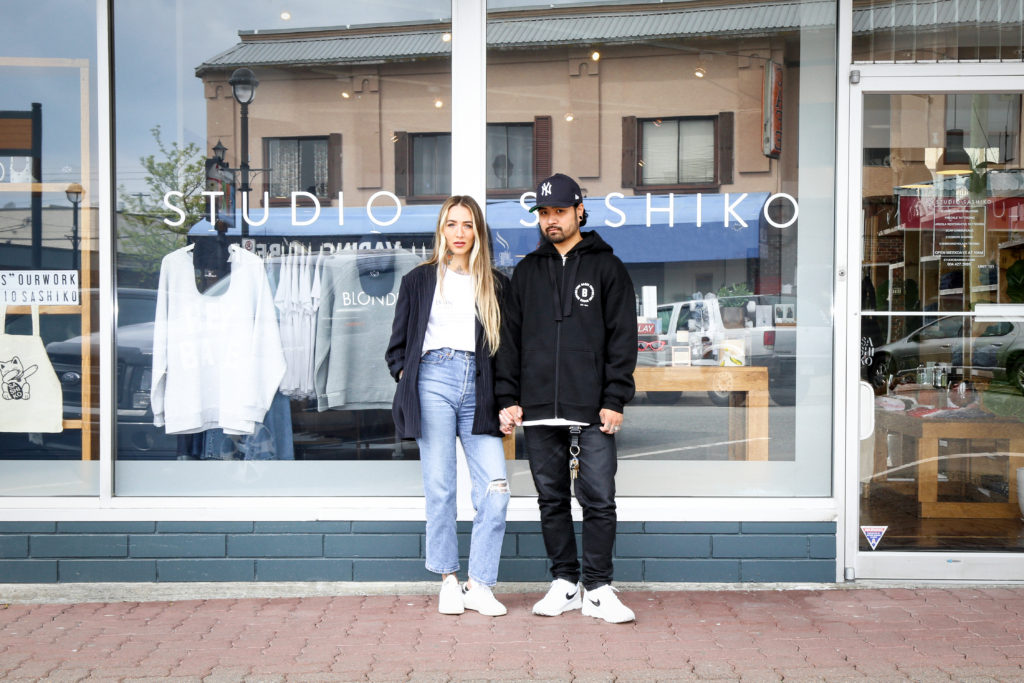 Female founder Shaughnessy Otsuji and Kyle Otsuji are photographed standing outside of their business, Studio Sashiko.