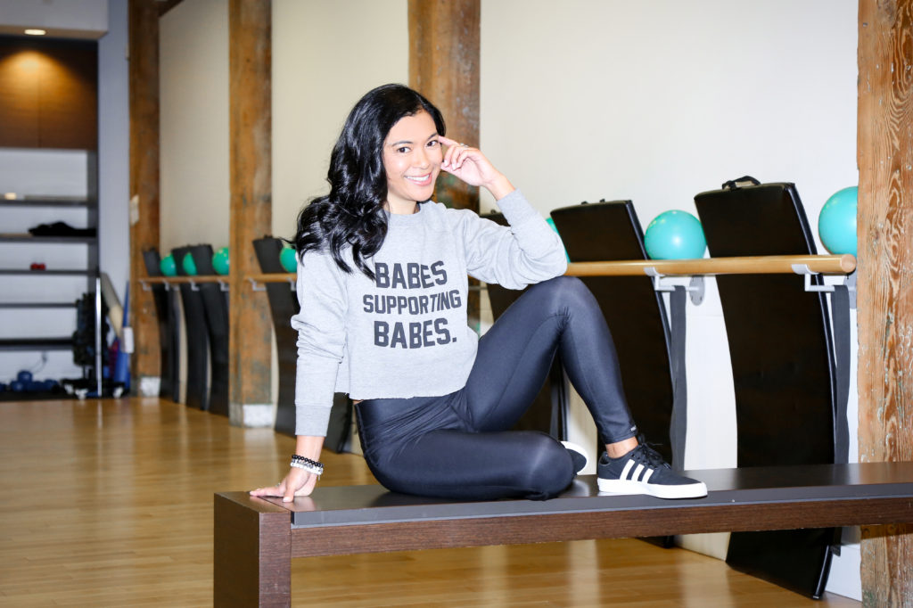 Female founder Ella Jotie of Barre Fitness is photographed sitting in their Vancouver-based barre studio.