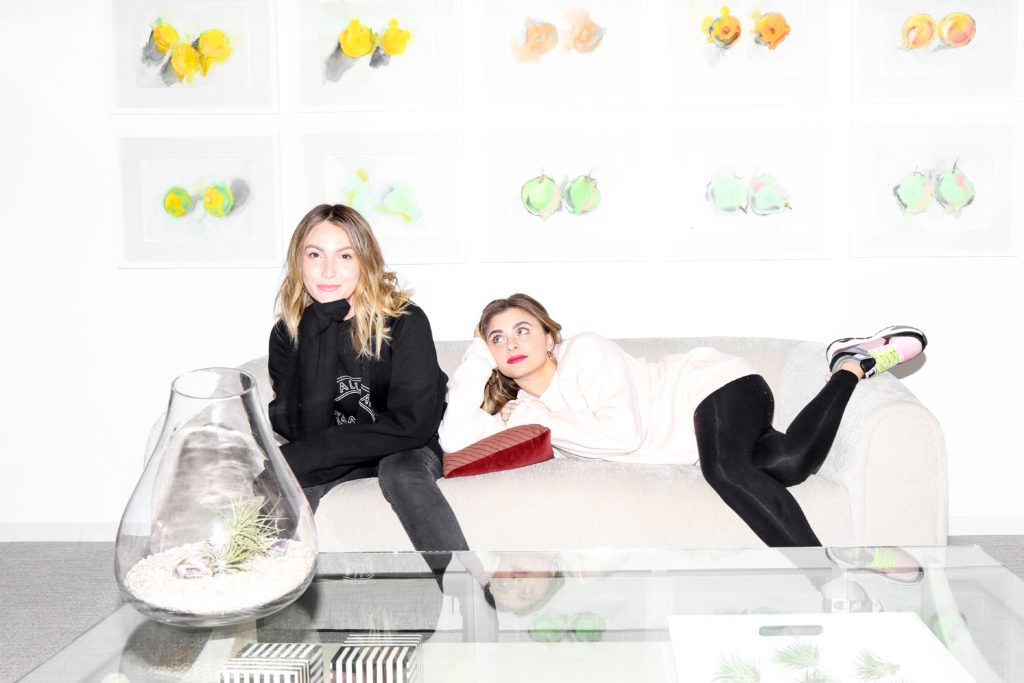 The female entrepreneurs behind That's So Retrograde podcast, Elizabeth Kott and Stephanie Simbari, are photographed sitting at the office of Dear Media.
