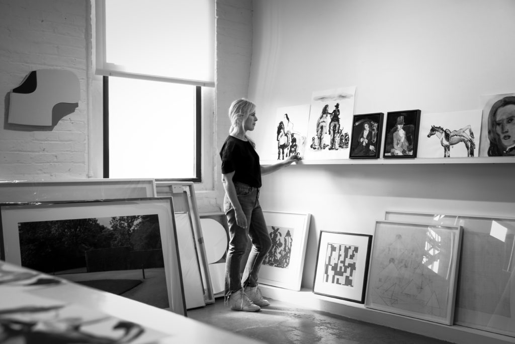Female artist Suzy Spence is photographed looking at her paintings at her New York studio.