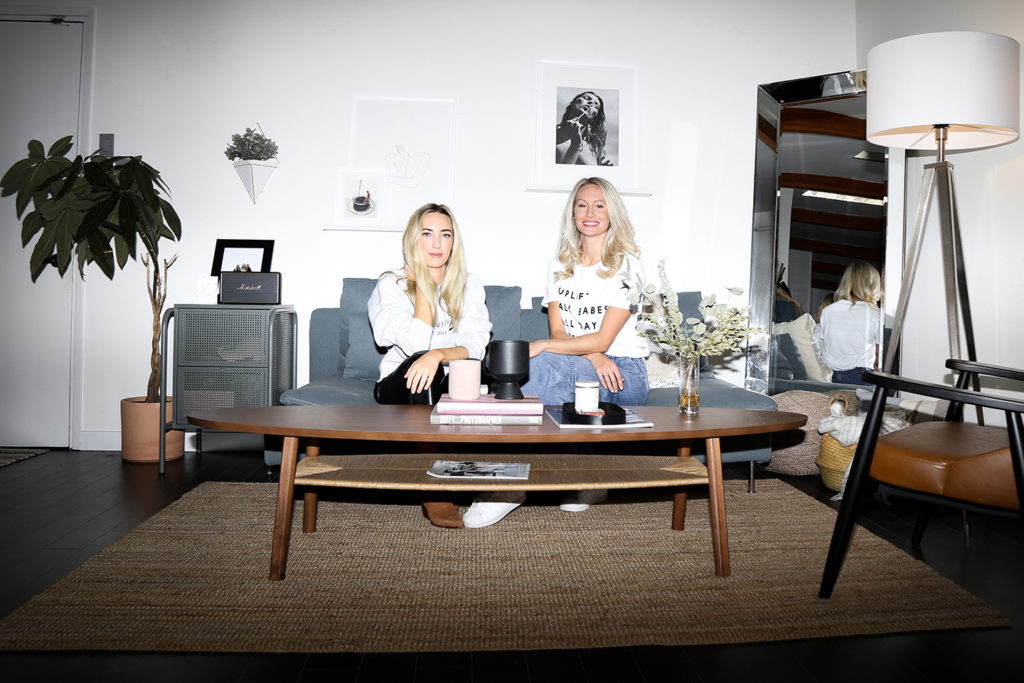 Female entrepreneurs Sam Ellis and Hannah Bernard are photographed sitting at the office of Roots and Ardor.